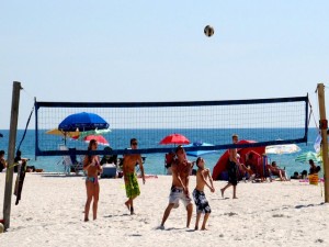 Kids playing volleball on the beach